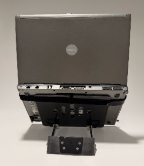 Front view of the completed laptop mount prototype, showing the custom bent-metal connector and mounting hardware