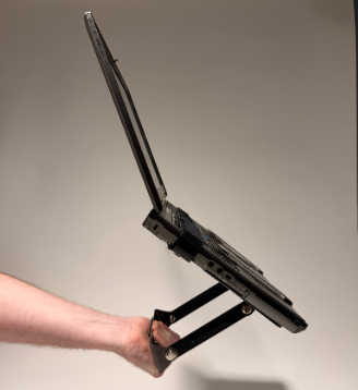 Completed laptop mounting prototype shown being held for scale