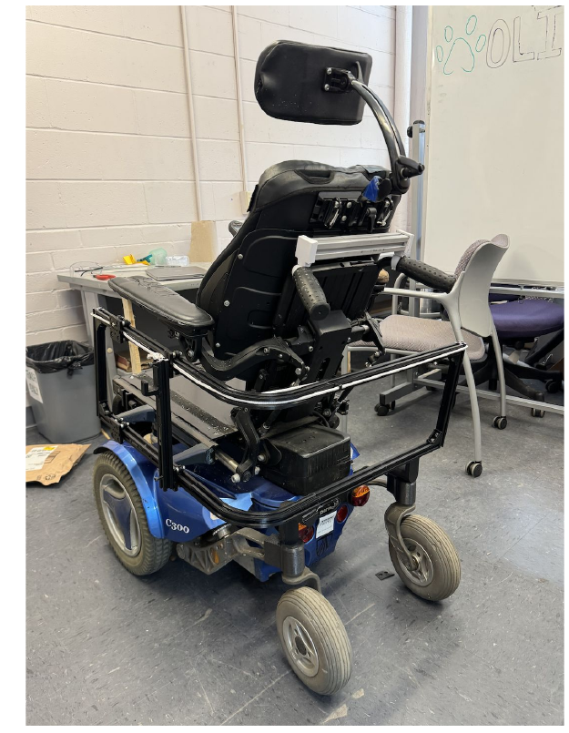 Rear view of a power wheelchair with the storage frame mounted around the back of the chair.